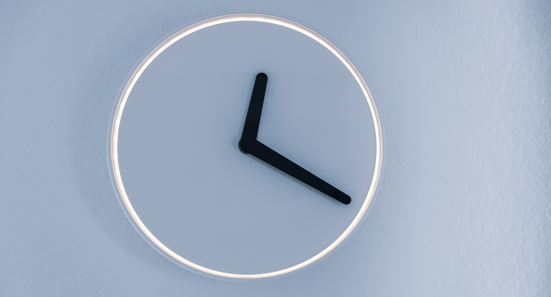a clock with no numbers or markings on a blue wall